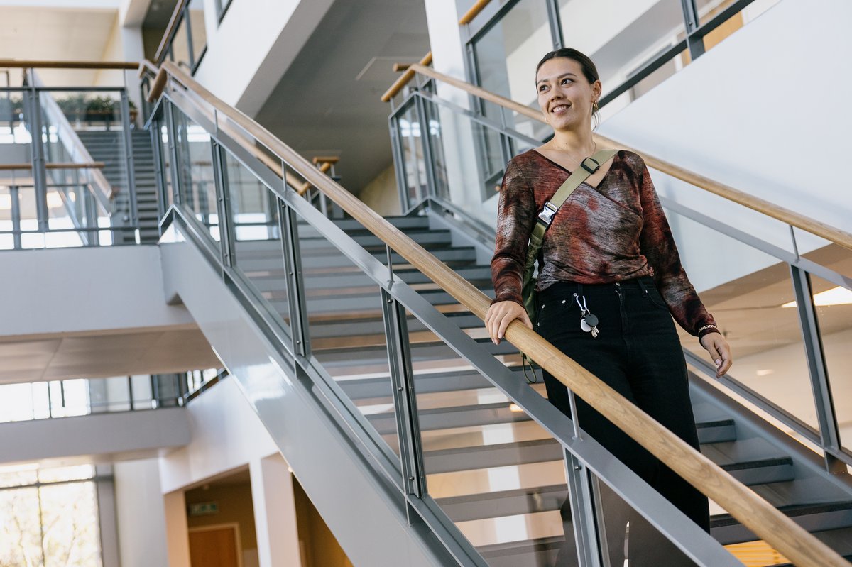 Nociline walking down the stairs at her office